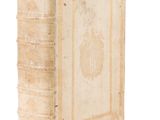 an old book sitting on top of a white surface