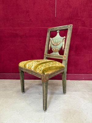 a chair that is sitting in front of a red wall