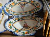 many plates and spoons that are on the table