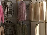 un placard avec des vêtements suspendus à une tringle et d'autres sur des cintres