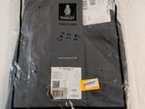 a bag of clothing wrapped in plastic on a white surface