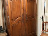 une armoire en bois dans une pièce au sol en damier