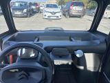 a view of a car from the driver ' s seat in a parking lot
