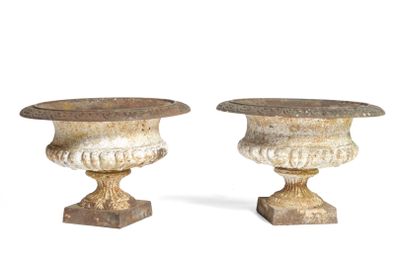 two vases sitting next to each other on a white surface