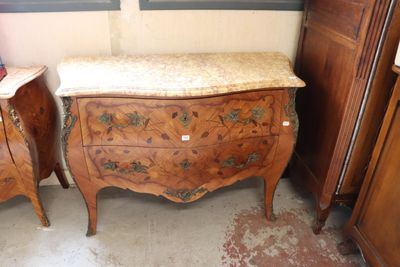 two wooden dressers with marble top tops in a room