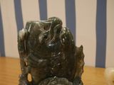 a statue of a frog that is sitting on a table