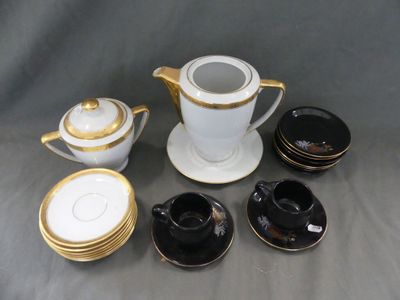 cinq tasses et soucoupes ainsi qu'une théière sur la table