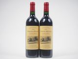 two bottles of wine sitting next to each other on a table