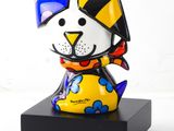 brightly colored dog figurine on black base on white background