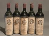 four bottles of wine are lined up on a table