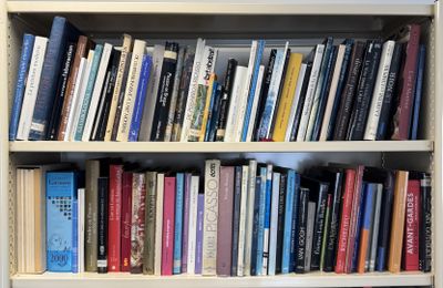 a bookshelf with many books on it in a room