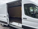 a white van with its doors open in a parking lot