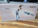 packaging of babylis curler on a wooden table in a kitchen