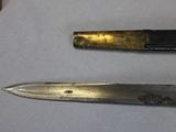 two knives sitting on a table next to each other