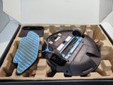 a box with a vacuum cleaner and a cloth in it