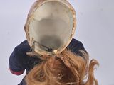 a doll that has a hat on it ' s head