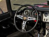 a steering wheel and dashboard of a car on the street