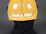 yellow hard hat on a mannequin head on a grey background