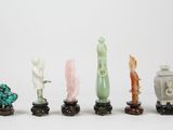 several pieces of jade and jade figurines are lined up in a row