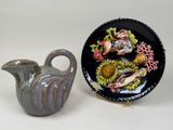 two vases and a plate sitting next to each other on a table