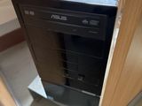 a black computer sitting on top of a wooden desk