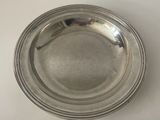 a silver plate on a table with a white background