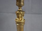 a gold candle that is on top of a table