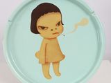 a plate with a picture of a girl smoking a cigarette