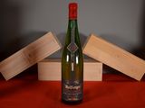 a bottle of wine sitting on a table next to a wooden box