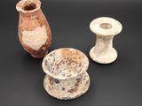 three pieces of pottery sitting on top of a table next to each other