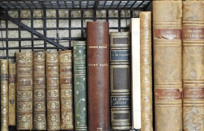 de nombreux livres anciens rangés sur une étagère d'une bibliothèque