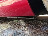 a red car that is parked on the side of the road