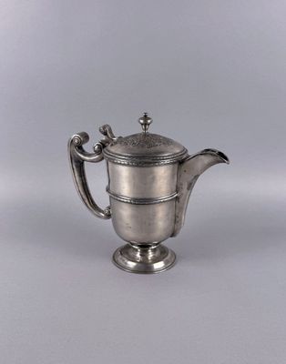 an antique silver teapot with a handle on a white background