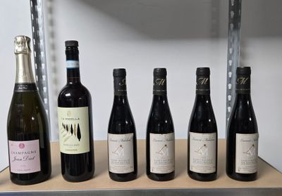 bottles of wine are lined up on a shelf in a wine cellar