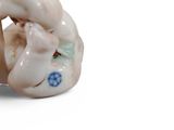 a figurine of a baby laying on its back