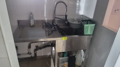 a kitchen with a sink and a counter with a faucet in it