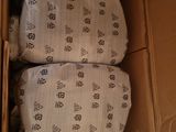 two pillows in a cardboard box on top of each other