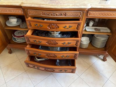 a wooden cabinet with a marble top and a marble counter top