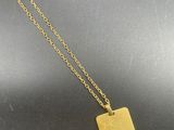 a gold plated necklace with a small square pendant on a gold chain