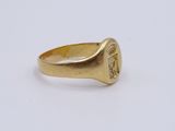 a close up of a gold ring with a signet on it