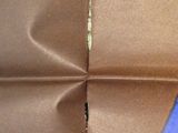 a piece of brown paper that has a blue triangle on it