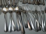 a lot of silver spoons and forks on the table