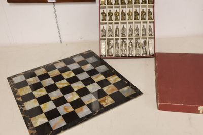 two books and a chess board sitting on a table
