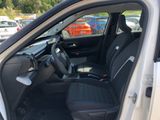the interior of a car with the door open and the passenger seat down