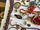a white table with a bunch of jewelry on it