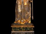 an image of a statue of a man holding a staff