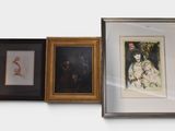 three framed pictures on the wall of a room