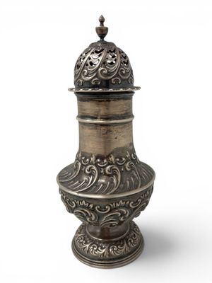 an ornate silver vase with a lid on a white background