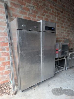 an image of a stainless steel refrigerator in a garage