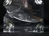 a glass sculpture of a fish in the shape of a bear